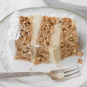 Veganer Kokoskuchen 11 Ein appetitliches Stück veganer Kokoskuchen auf einem weißen Teller