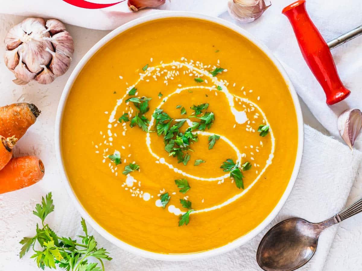 Karottensuppe in einer weißen Schale mit Petersilie