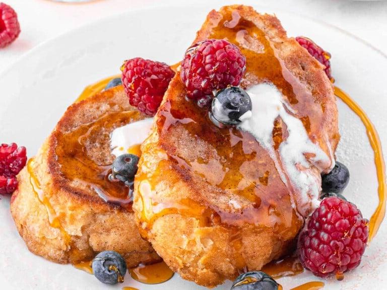 Vegan French toast with vegan butter, berries and maple syrup.