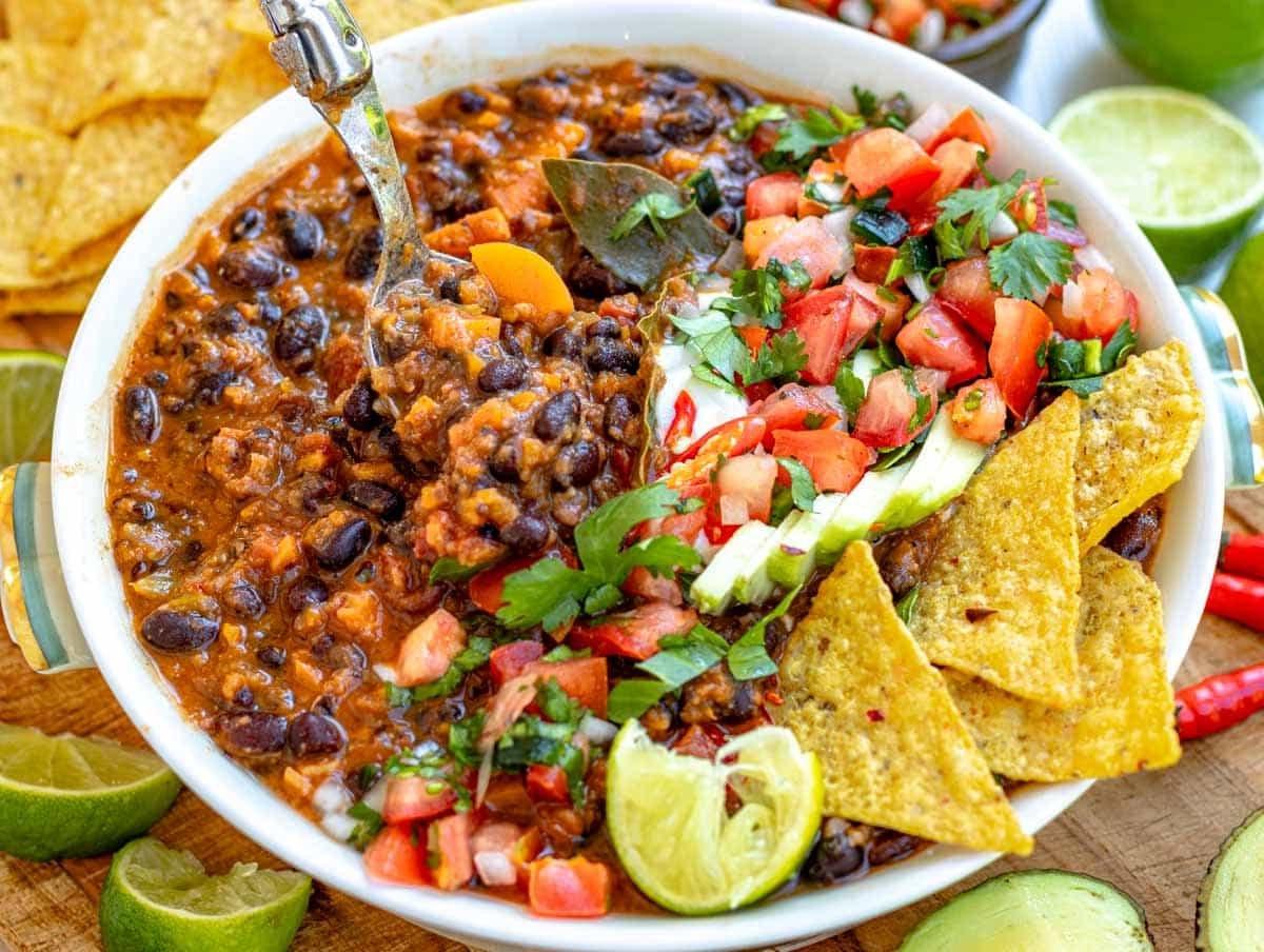 black bean soup topped with tortilla, pico de gallo, avocado, sour cream, cilantro, and lime juice.