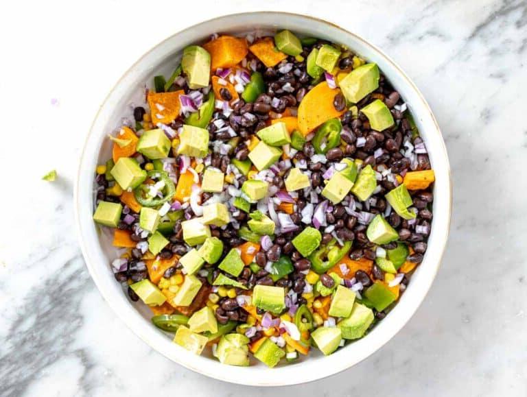 black beans, avocado, and sweet potatoes in a white bowl