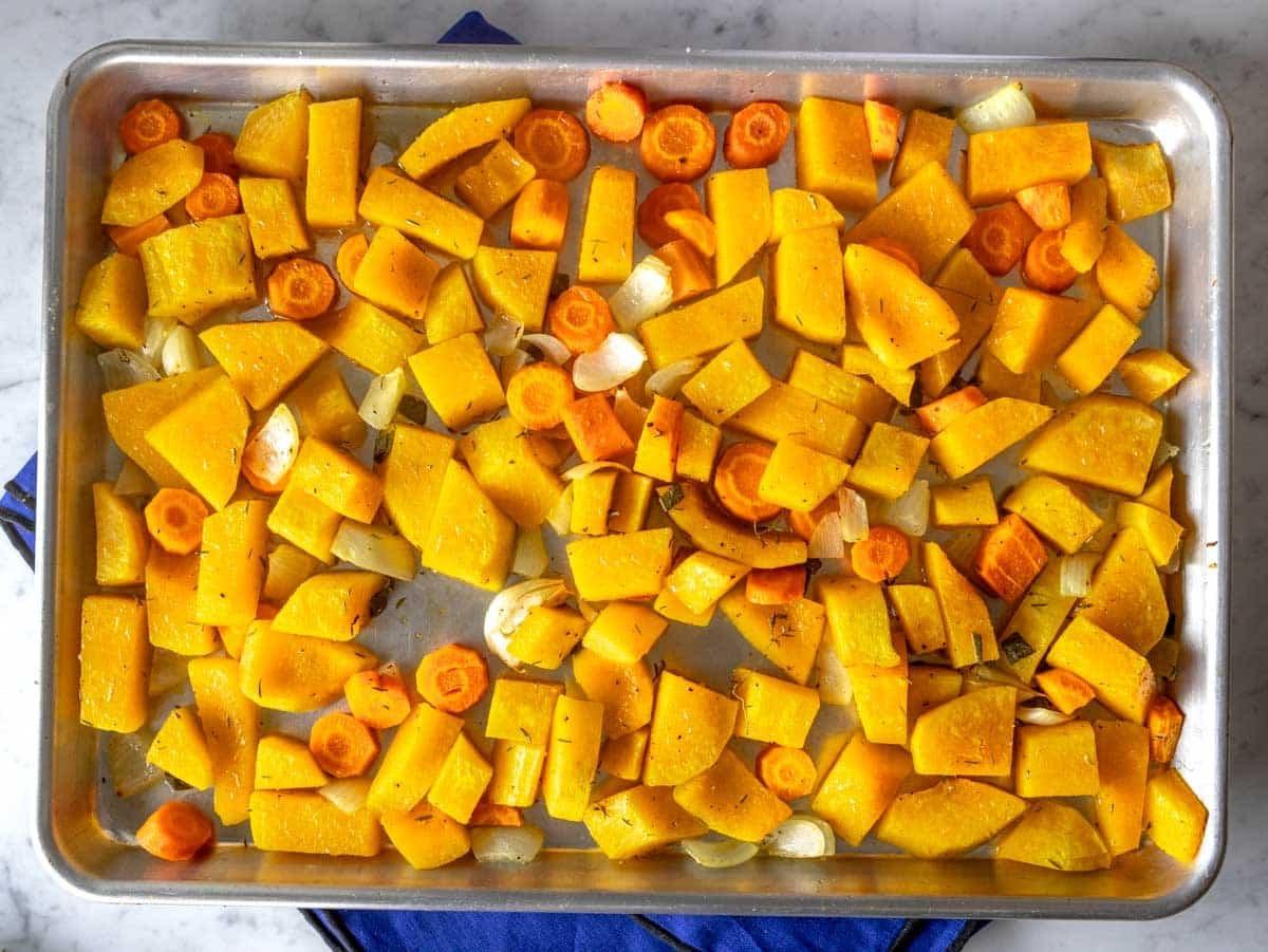 Roasted butternut squash and carrot on a baking tray