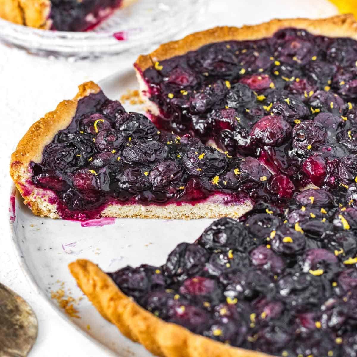 Frische Blaubeertarte mit Puderzucker bestreut.