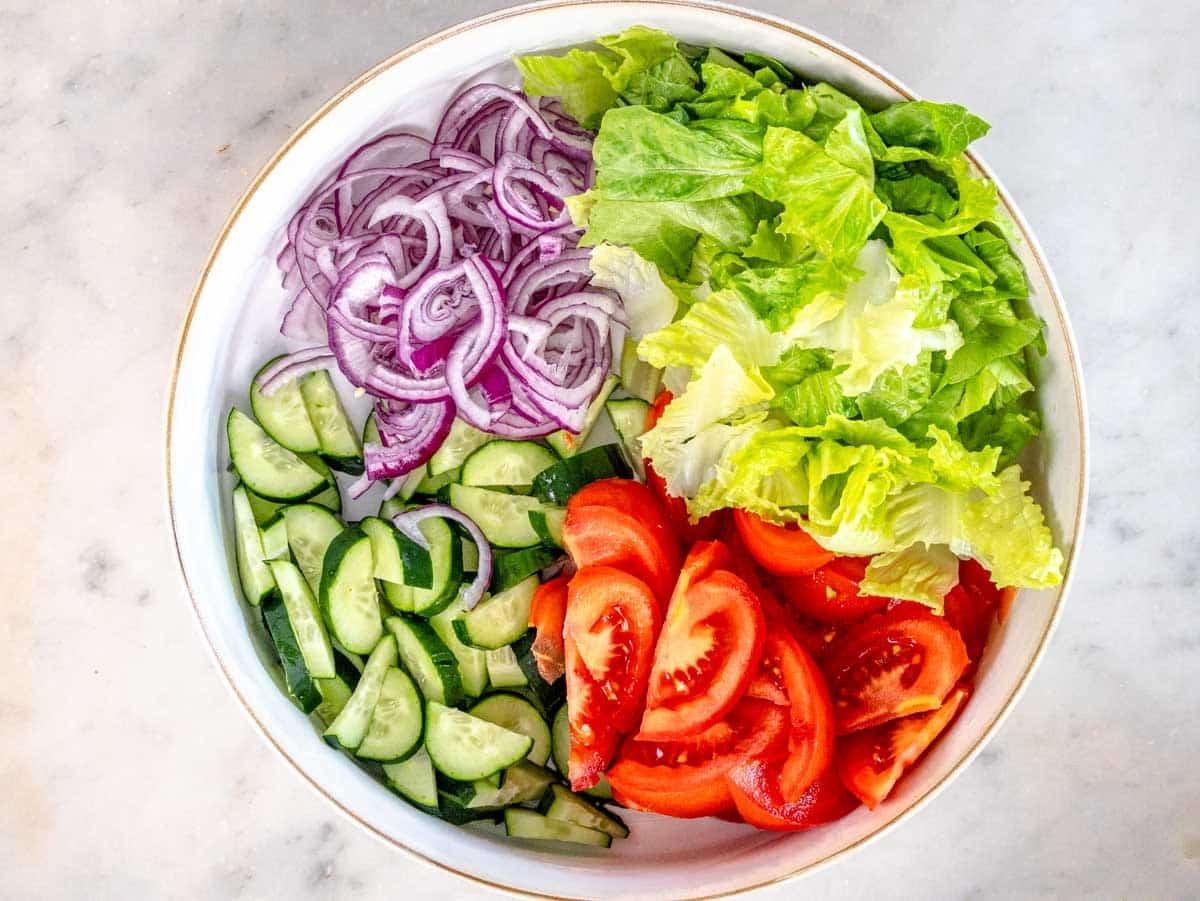 Salat, Tomaten und Gurke in einer weißen Schüssel